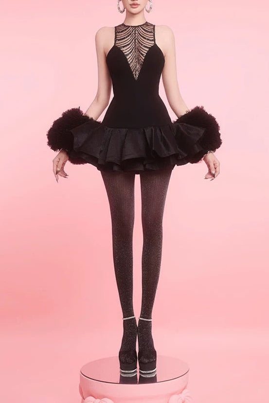 Dancer in a black leotard with ruffled skirt on a pink background